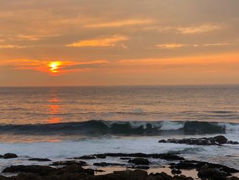 Scenic view of sea against sky during sunset