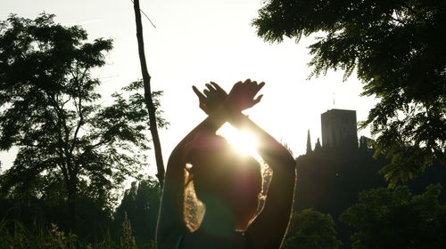 Low angle view of silhouette sculpture against sky