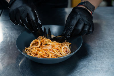 Midsection of man holding food on table