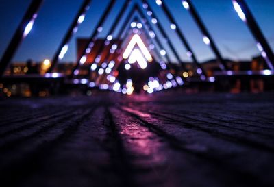 Surface level of illuminated bridge at night