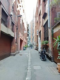 Narrow street amidst buildings in city