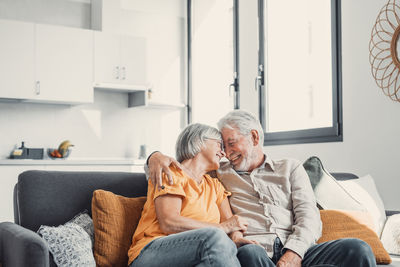 Side view of family sitting at home