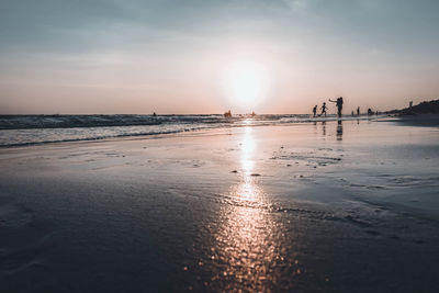 Scenic view of beach against sky during sunset