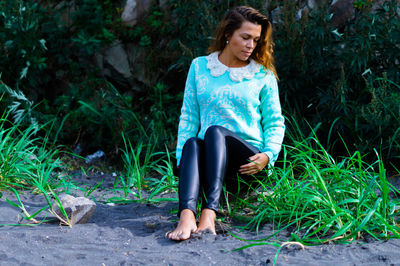 Woman in a smiling while sitting on plants