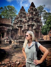 Portrait of woman standing against old ruins