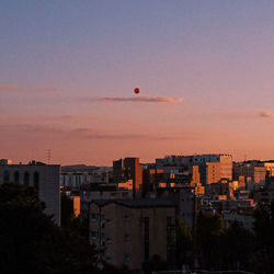 High angle view of buildings against sky at sunset