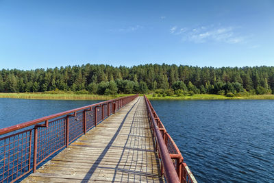 Scenic view of lake in forest against sky