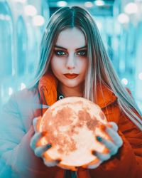 Portrait of young woman holding ice cream