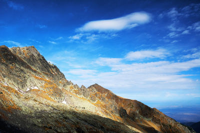 Low angle view of mountains against blue sky