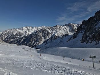 Scenic view of snow covered mountains against sky