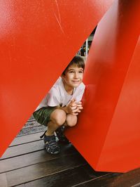 Boy sitting in red hat