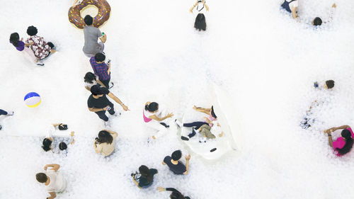 High angle view of people playing in snow