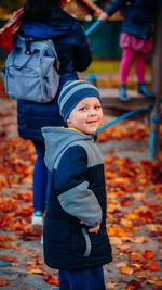 Rear view of father and son during autumn