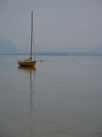 Sailboat on sea against sky