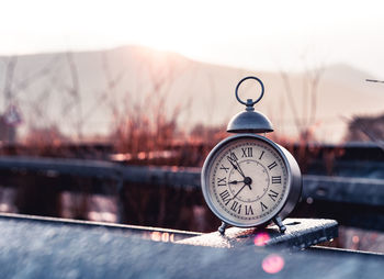 Close-up of clock on snow covered table