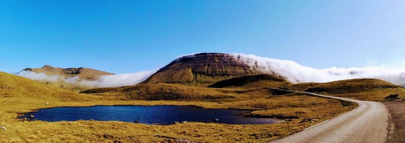 Scenic view of mountains against clear blue sky