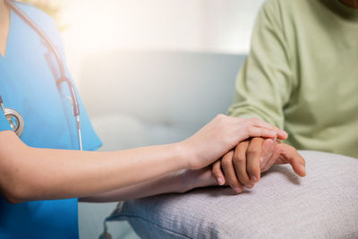 Midsection of doctor examining patient