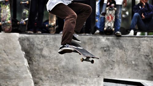 Low section of man skateboarding at playground