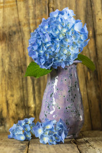 Close-up of purple flower vase on table