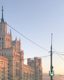 Buildings in city against clear sky