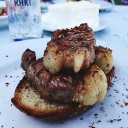 High angle view of grilled meat with bread in plate