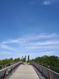 Footbridge against blue sky