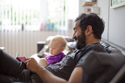 Father with baby girl on sofa