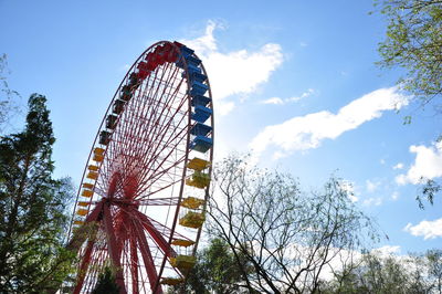 Low angle view of ferris wheel against blue sky