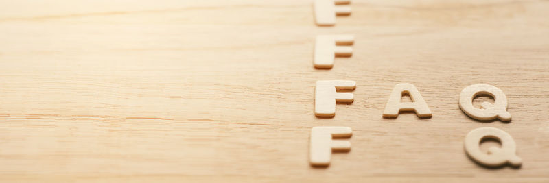 Close-up of text on wooden table