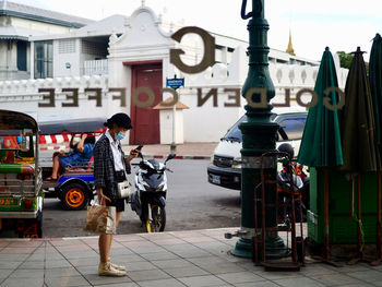 Rear view of people on street in city