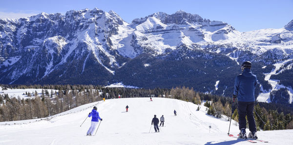 People skiing on snowcapped mountain