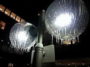 Low angle view of light bulb at night