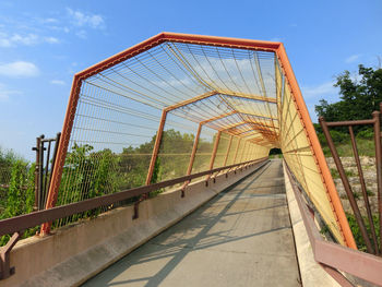 Covered footbridge against sky