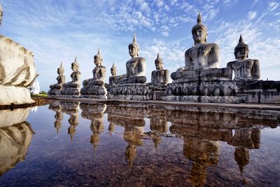 Statue of historic temple against sky