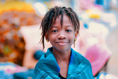 Portrait of smiling cute girl with dreadlocks