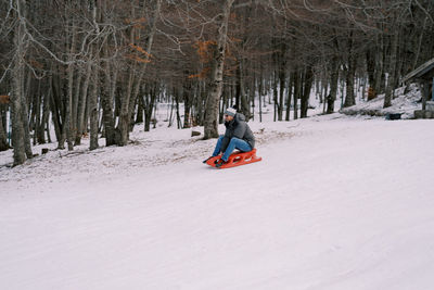 Man skiing on snow covered field