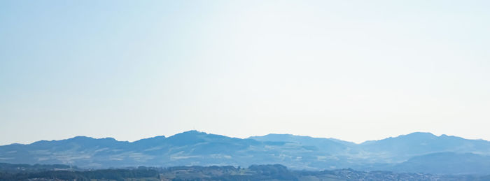 Scenic view of snowcapped mountains against clear sky