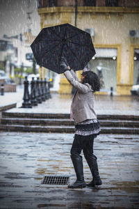 Woman enjoying rain in city