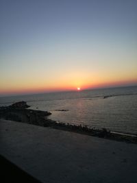 Scenic view of sea against clear sky during sunset