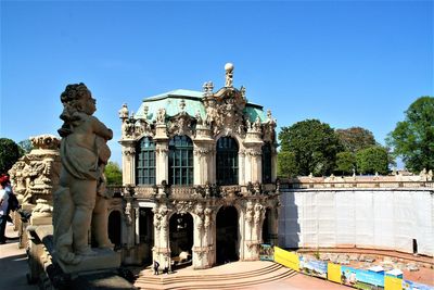 Statue of historic building against blue sky