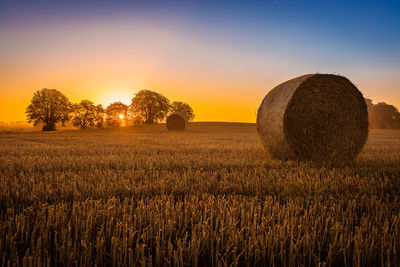 Haystack in denmark with the sun setting behind
