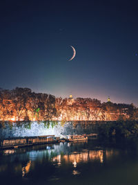 Scenic view of lake against clear sky at night