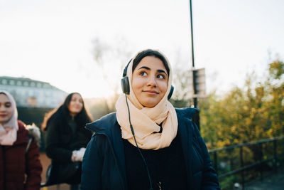 Portrait of beautiful young woman standing in winter