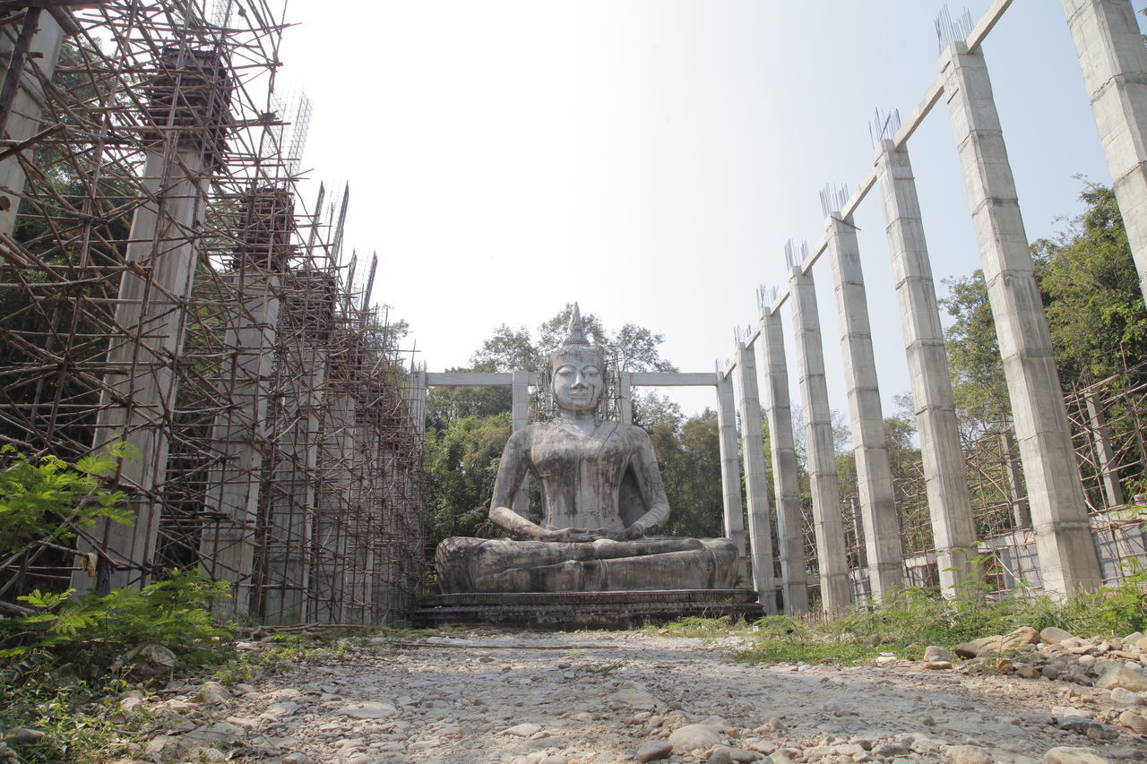 STATUE AGAINST TREES