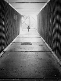 Rear view of man walking on footpath