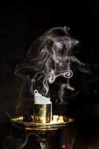 Close-up of wineglass against black background