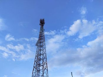 Low angle view of communications tower against sky