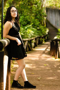 Full length of smiling woman standing outdoors