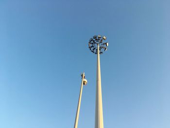 Low angle view of windmill against clear blue sky