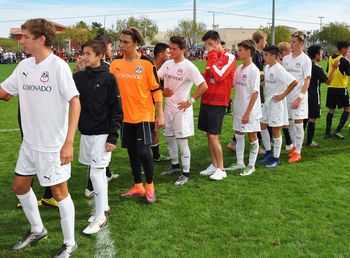 Group of people standing on soccer field